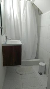 a bathroom with a sink and a shower with a toilet at Jose Luis Hostal Boutique in Lima +36 photos