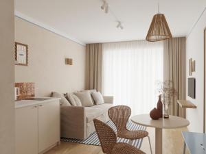 a living room with a couch and a table at Złota 34 Karwia in Karwia