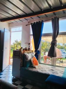 a living room with a couch and a window at le Cabanon Beldi in Rabat