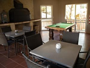 a dining room with a pool table and chairs at Stay in Postmasburg