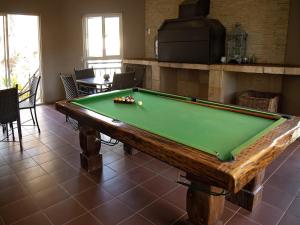 a pool table in a living room with afits at Stay in Postmasburg +15 photos