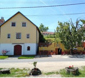 a large yellow house on the side of a road at Andělský sklípek in Dolní Věstonice