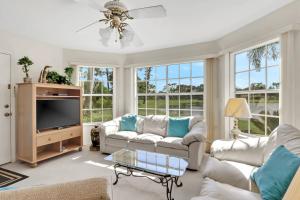 a living room with couches and a tv at 4111 Gunnison Ct #1214 in Estero