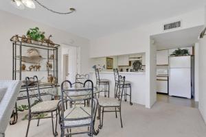 a kitchen and dining room with a table and chairs at 4111 Gunnison Ct #1214 in Estero