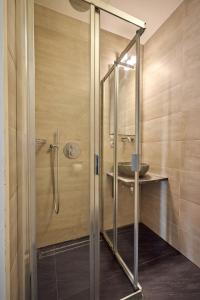 a shower with a glass door and a sink at Quentin Museum Square Hotel in Amsterdam +44 photos