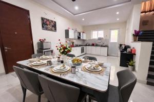 a kitchen and dining room with a table and chairs at Premium Villa Stay Near the Airport Perfect for Families & Business Travelers in Hyderabad