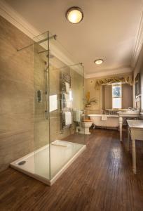 a bathroom with a glass shower and a tub at Washingborough Hall Hotel in Lincoln +59 photos