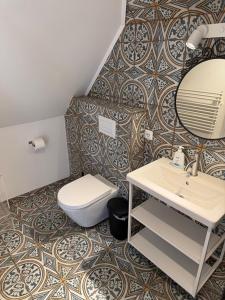 a bathroom with a toilet and a sink and a mirror at BoLA 20 Fewo Hamburg mit Parkplatz & 2 SZ in Hamburg