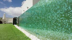 a large glass wall with a water feature at URBANSEA Bex in Las Palmas de Gran Canaria