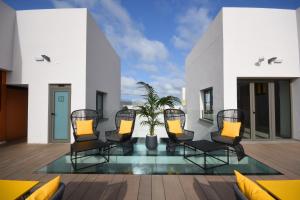 a deck with chairs and a potted plant at URBANSEA Bex in Las Palmas de Gran Canaria