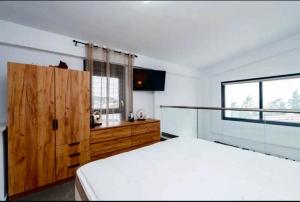 a bedroom with a white bed and a window at Diamond Deluxe Loft in Iraklitsa