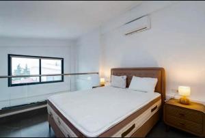 a bedroom with a large bed and a window at Diamond Deluxe Loft in Iraklitsa
