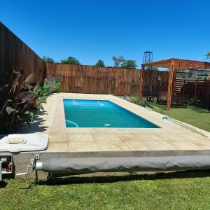 a swimming pool in a backyard with a wooden fence at La Su in Duggan