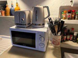 a coffee maker on top of a microwave on a counter at La Catounière - Maison de village avec magnifique vue in Mons