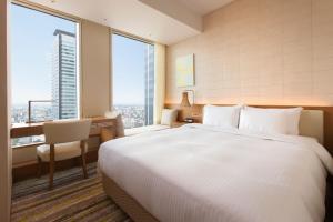 A bed or beds in a room at Nagoya JR Gate Tower Hotel
