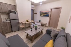 a living room with a couch and a table and a kitchen at Aurora apartments Room 1 in Marmari +16 photos
