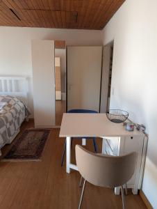 a room with a table and two chairs and a bed at Helles, sonniges, ruhiges Apartment in Wuppertal