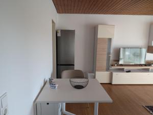 a kitchen with a white table and a refrigerator at Helles, sonniges, ruhiges Apartment in Wuppertal