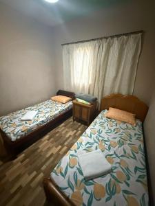two beds sitting in a room with at Alanna temporada in Olímpia +34 photos