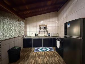 a kitchen with a stainless steel refrigerator and a floor at Alanna temporada in Olímpia