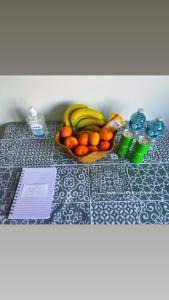 a table with a basket of fruit on it at The Cosy Cumbrian Homestay in Penrith