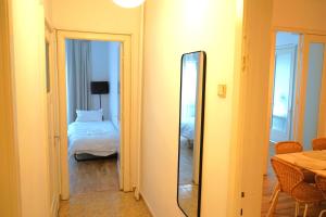 a mirror in a room with a bed and a bedroom at Spacious 3BR, 2BT with 5 balconies in Bucharest
