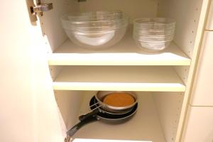 a cupboard with three bowls and a mortar and pestle at Spacious 3BR, 2BT with 5 balconies in Bucharest +70 photos