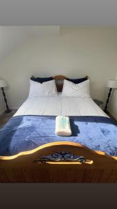 a bed with a pair of scissors on it at The Cosy Cumbrian Homestay in Penrith