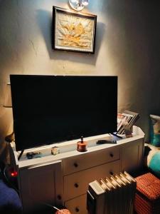 a flat screen tv sitting on top of a dresser at le Cabanon Beldi in Rabat