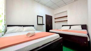 a bedroom with two beds with a phone on it at Haputale Hills Holiday Home in Haputale