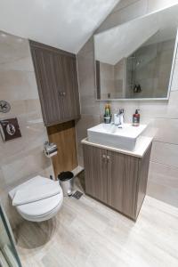 a bathroom with a toilet and a sink at Aurora apartments Room 1 in Marmari