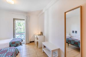 a room with two beds and a mirror at HI Guarda - Pousada de Juventude in Guarda