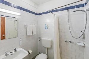 a bathroom with a shower and a toilet and a sink at HI Guarda - Pousada de Juventude in Guarda