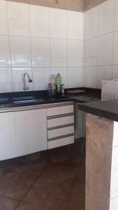 a kitchen with a sink and a counter top at Casa de Trindade-Go in Trindade