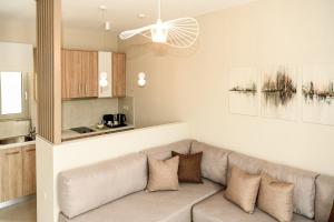 a living room with a couch and a kitchen at Abelia Abode Apt in Kavros