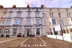 a large white building with a sign in front of it at Del Mar in Llandudno