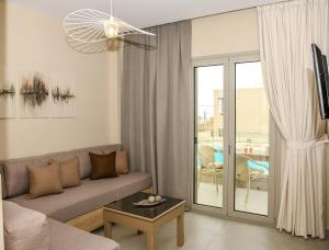a living room with a couch and a table at Abelia Abode Apt in Kavros