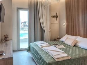 a hotel room with a bed and a window at Abelia Abode Apt in Kavros +37 photos