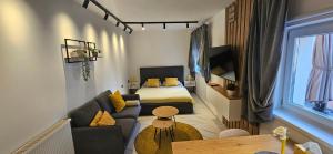 a small living room with a bed and a couch at Apartments Lisinski - FREE parking in Zagreb