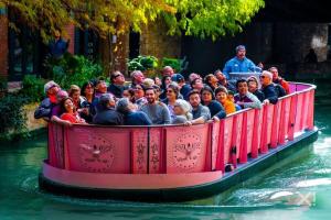 a group of people riding on a train in the water at SeaCasa San Antonio in San Antonio +32 photos
