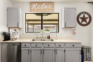 a kitchen with a sink and a window at SeaCasa San Antonio in San Antonio