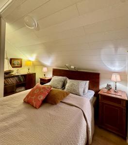 a bedroom with a large bed and two night stands at Villa Santala in Naantali
