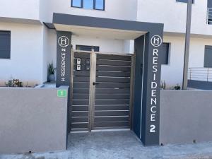 a entrance to a building with a garage at H residence 2 in Artemida +2 photos