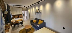 a living room with a couch and a table at Apartments Lisinski - FREE parking in Zagreb