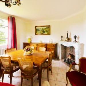 a dining room with a table and a fireplace at La maison de Dourils in Entraygues-sur-Truyère +6 photos