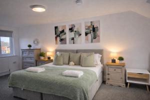 a bedroom with a bed with two pillows on it at York Boutique House- spacious & stylish with free parking in York