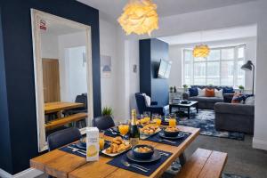 a living room with a table with food on it at York Boutique House- spacious & stylish with free parking in York +8 photos