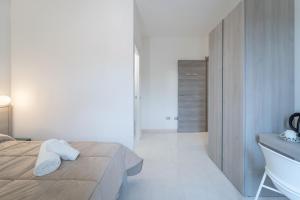 a bathroom with a bed and a sink and a tub at Via del Mare in Giba