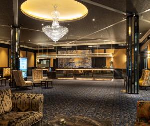 a lobby of a hotel with a chandelier at The Grand Hotel in Malahide
