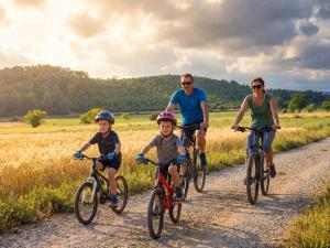 a family riding bikes down a dirt road at Camping Castelló Mar in Empuriabrava